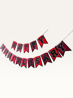 Paper Party Studio Happy Anniversary bunting with red swallowtail flags and black bubble letters on silver string.