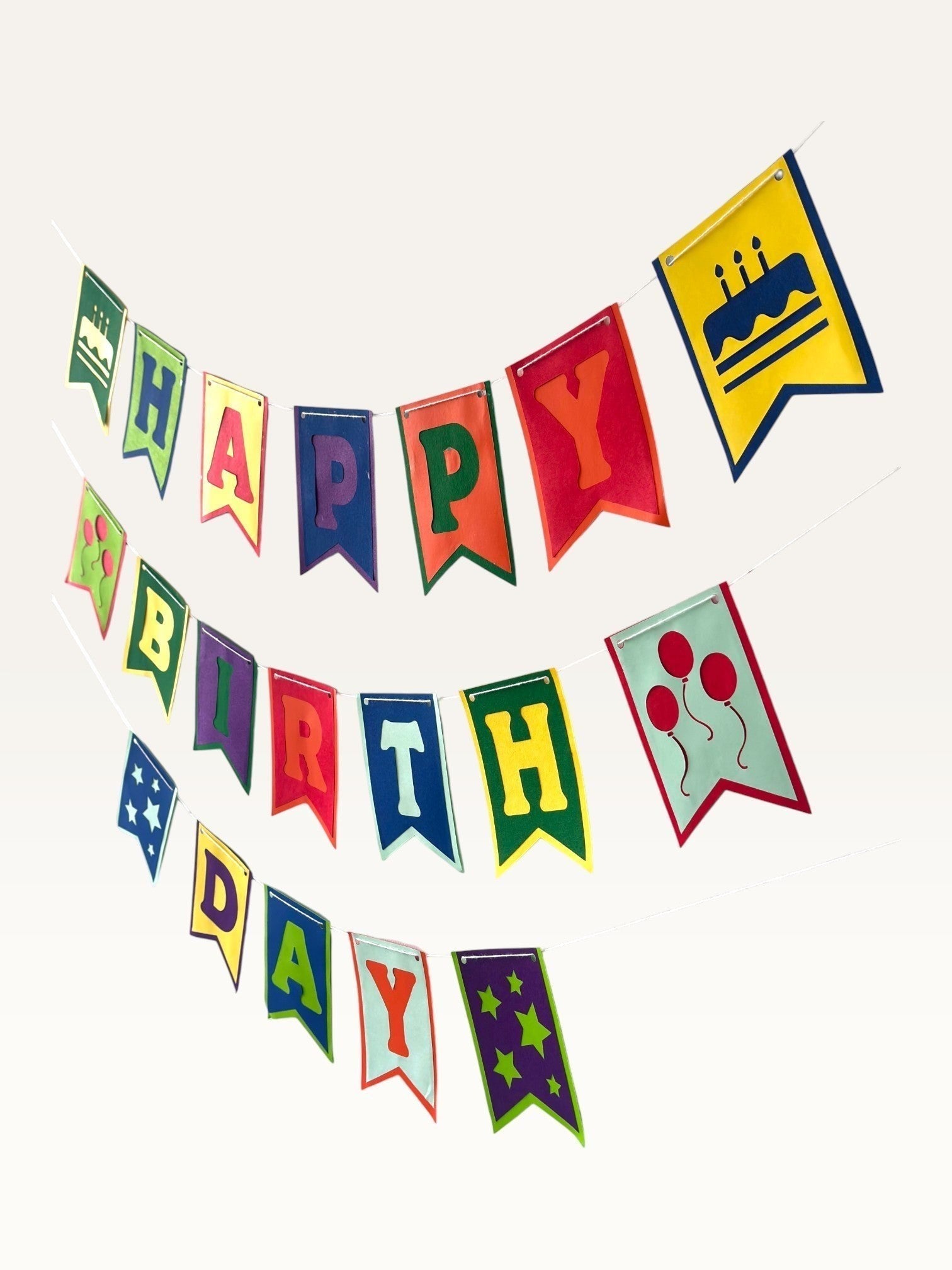Paper Party Studio multicolour Happy Birthday bunting with swallowtail flags, cake, balloon, and star decorations.