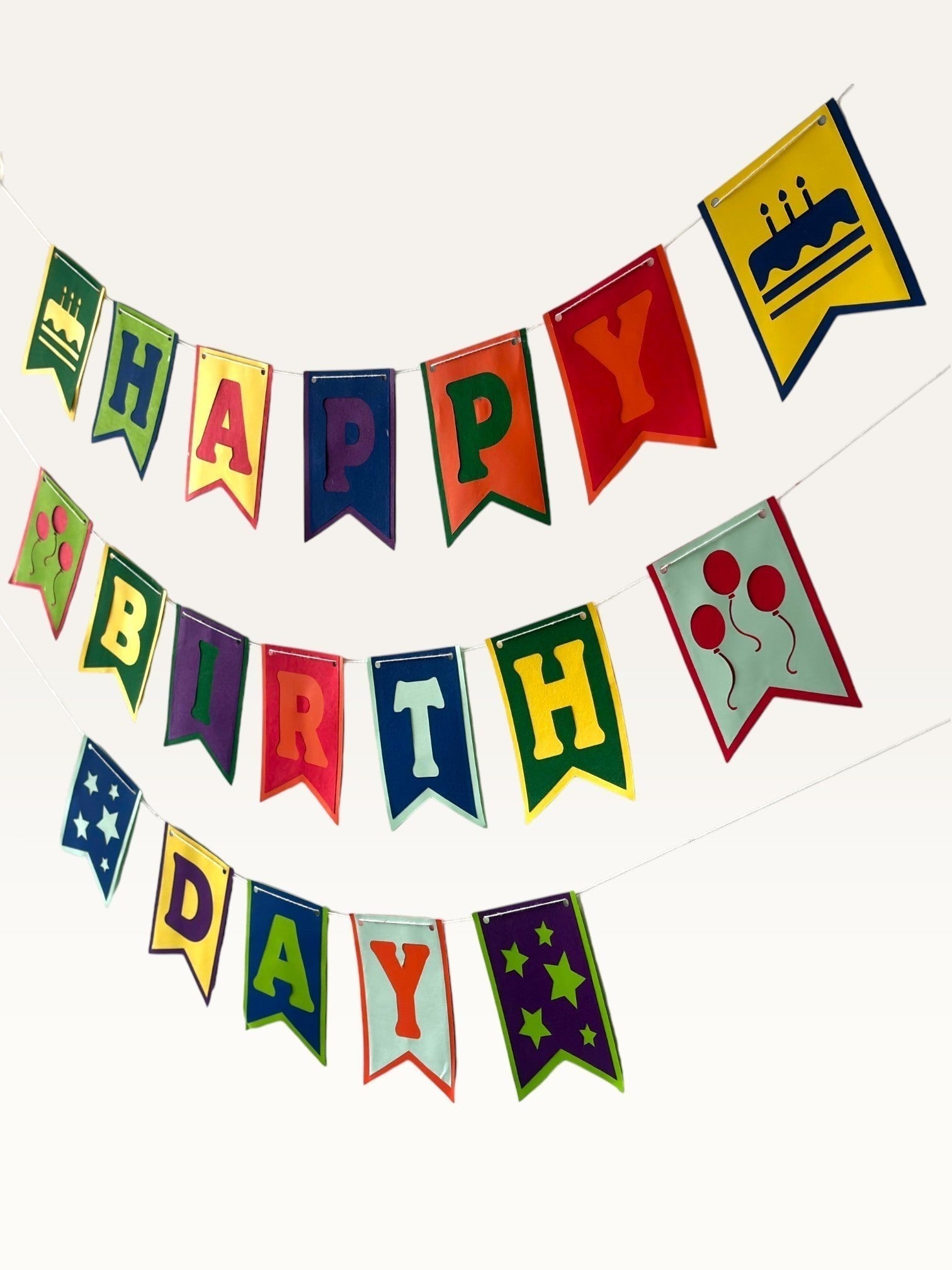 Paper Party Studio multicolour swallowtail Happy Birthday banner with cake, balloon, and star icons on cardstock.