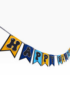 Paper Party Studio blue, sky blue, and gold paper birthday banner with bubble letters on swallowtail flags.