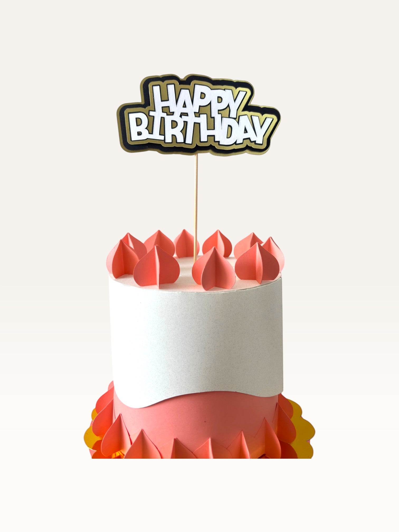 Paper Party Studio layered Happy Birthday cake topper with white lettering, black outline, and gold scalloped backing.