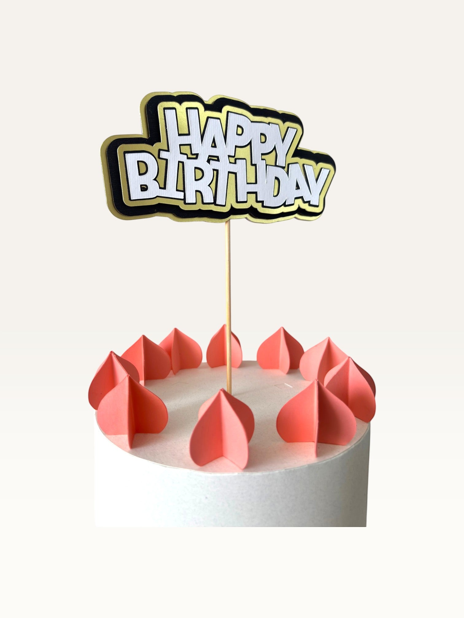 Paper Party Studio layered Happy Birthday cake topper with white lettering, black outline, and gold scalloped backing.