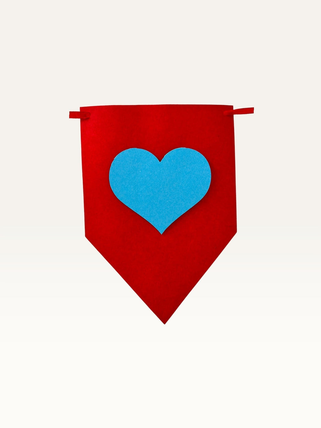 Paper Party Studio handmade red cardstock bunting flag with a layered blue heart for party decorations.