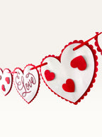 Paper Party Studio romantic heart bunting with scalloped white cardstock hearts and red script on a red cord