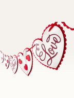 Paper Party Studio romantic heart bunting with scalloped white cardstock hearts on a red cord for Valentine's Day.