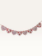 Paper Party Studio heart bunting with white scalloped cardstock hearts and red script on a red hanging cord.