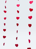 Paper Party Studio red heart garland streamers for romantic wedding or Valentine's Day party backdrop decor.