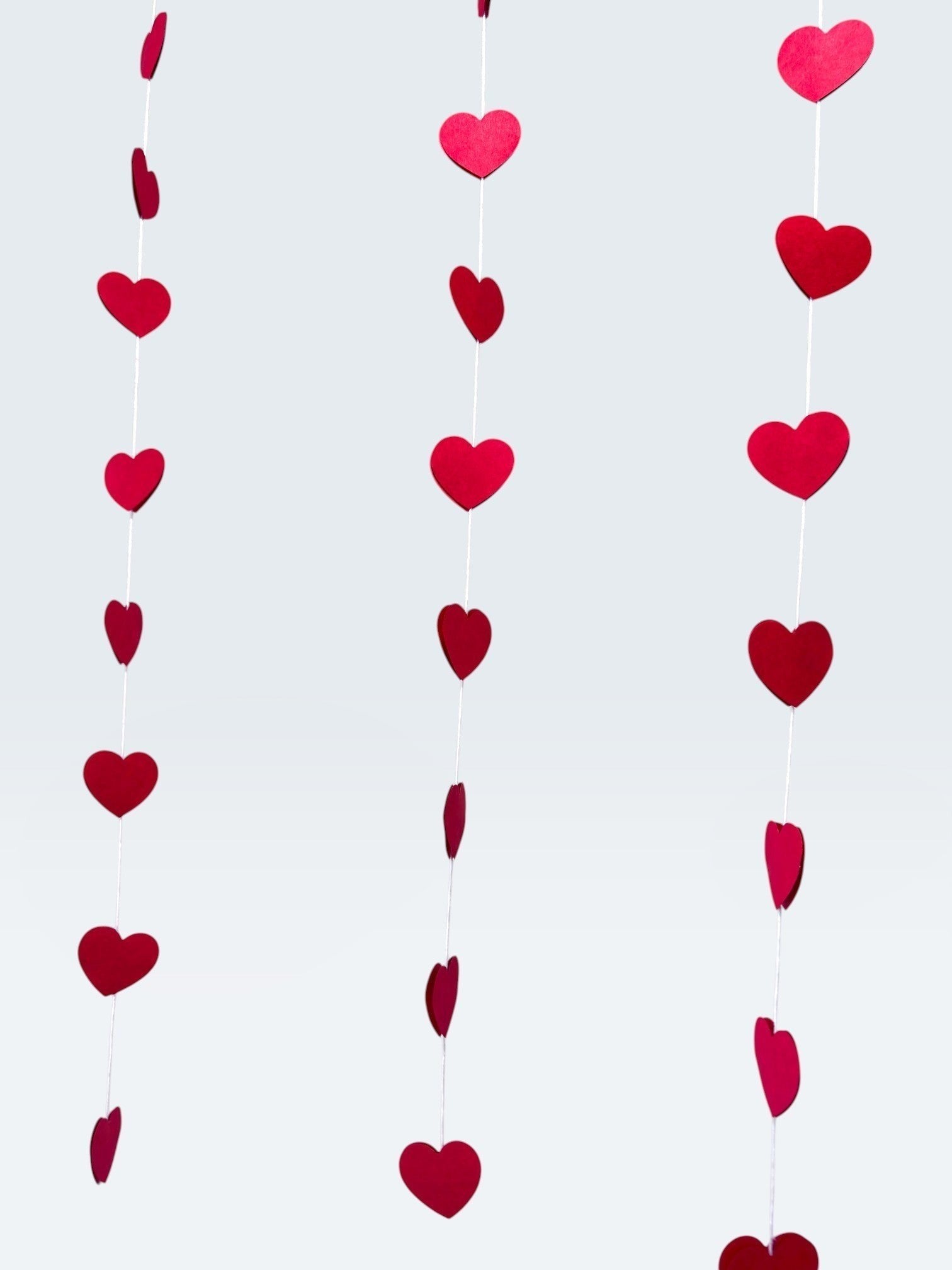 Paper Party Studio red heart garland streamers for romantic wedding or Valentine's Day party backdrop decor.