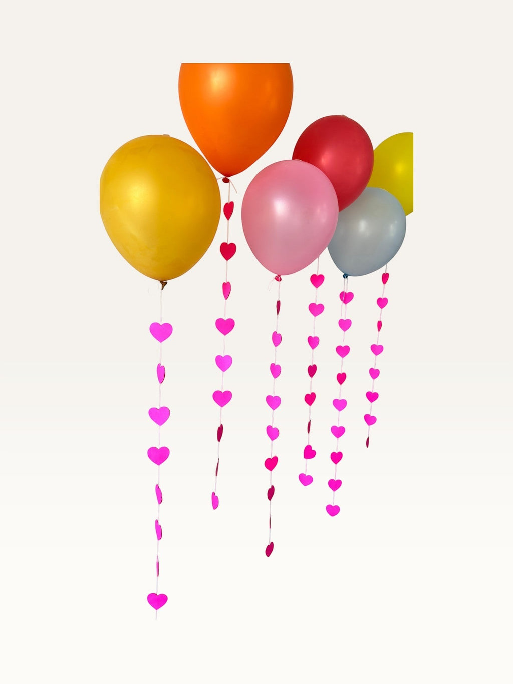 Paper Party Studio hanging pink heart garland strings for romantic wedding or Valentine's Day party backdrop decor.