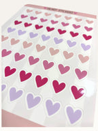 Paper Party Studio glossy kiss-cut sticker sheet featuring rows of pink, red, and lilac heart stickers.