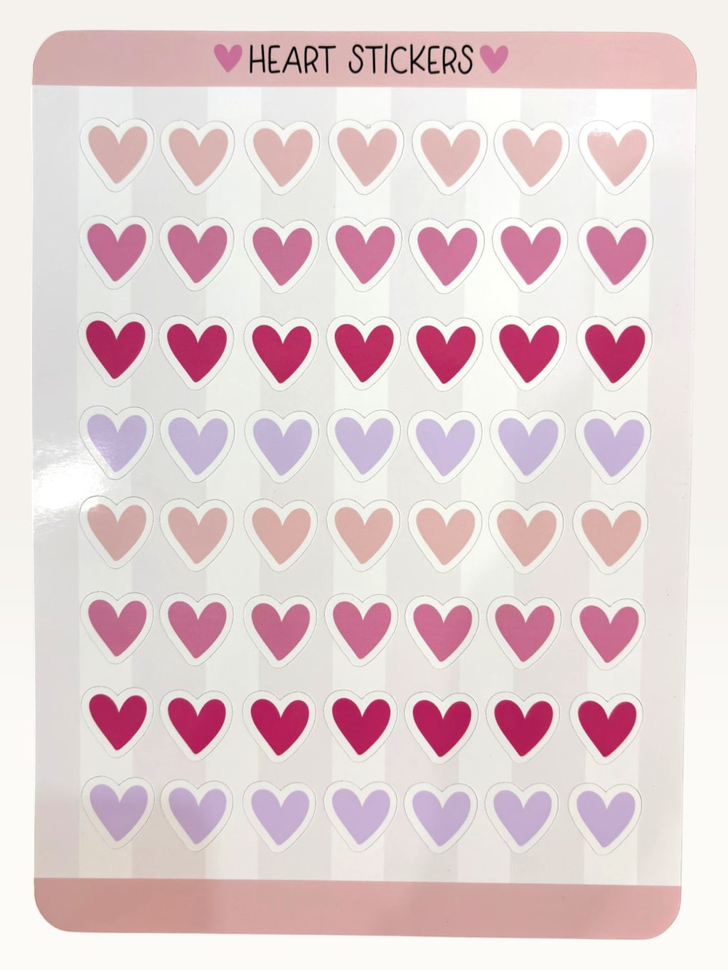 Paper Party Studio glossy heart sticker sheet with rows of pink, red, and lavender hearts for journals and crafts.