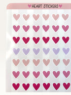 Paper Party Studio heart sticker sheet featuring rows of glossy pink, red, and lilac heart stickers on a white sheet.
