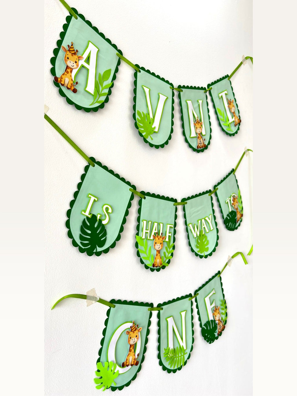 Paper Party Studio personalised jungle giraffe half-birthday banner with mint and forest green scalloped paper flags.