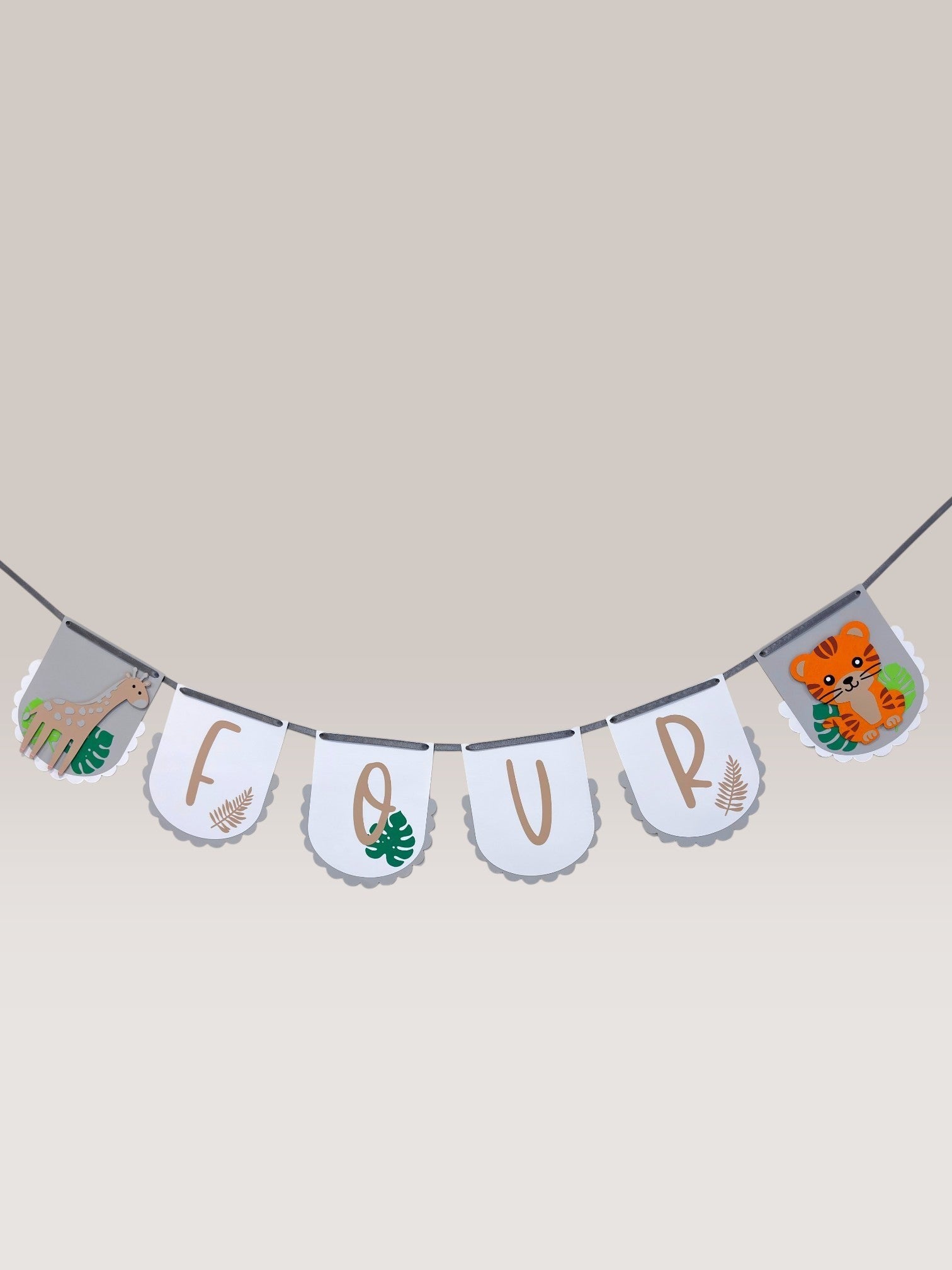 Paper Party Studio personalised jungle safari birthday banner featuring a giraffe, tiger, and the word FOUR in cream.