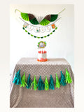 Paper Party Studio jungle safari birthday decoration set with personalised banner, cake topper, and paper tassels.