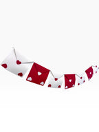 Paper Party Studio red and white envelope bunting with heart cut-outs, strung on silver cord.