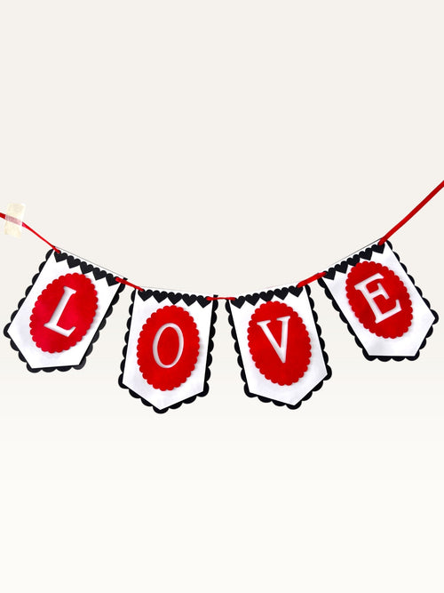 Paper Party Studio LOVE banner with red, black, and white scalloped paper flags and heart details for celebrations.