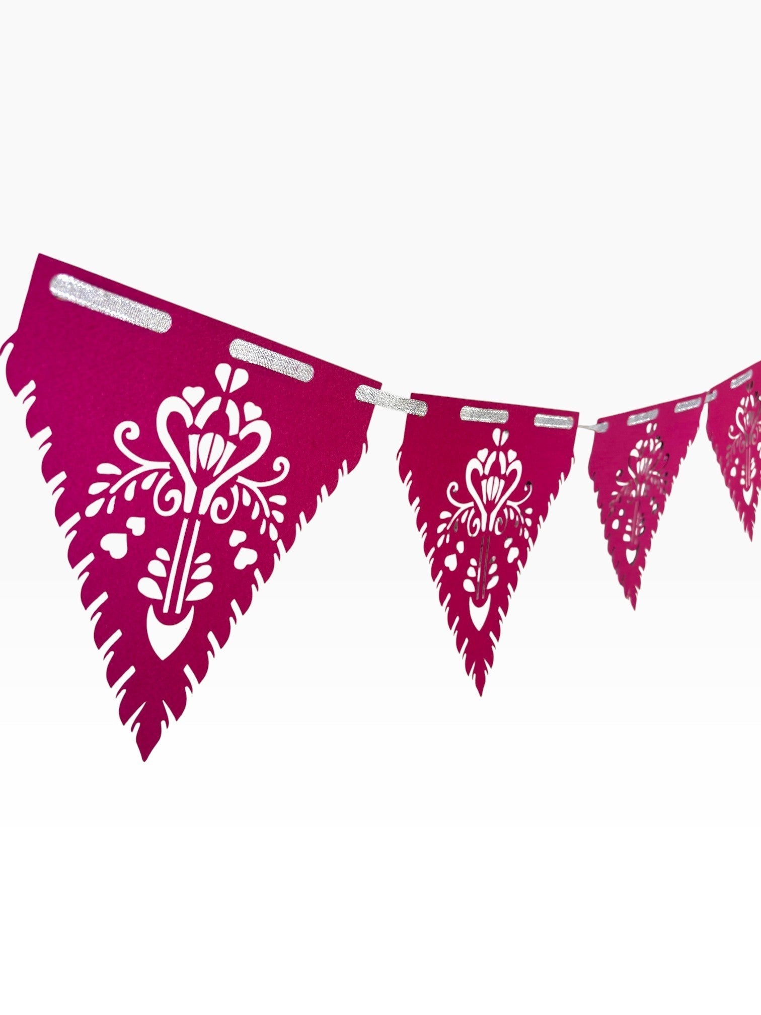 Paper Party Studio magenta papel picado bunting with intricate floral cut-outs and silver ribbon.