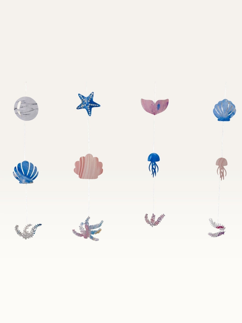 Paper Party Studio under the sea hanging backdrop with pink and blue cardstock shells, starfish, and mermaid tails.