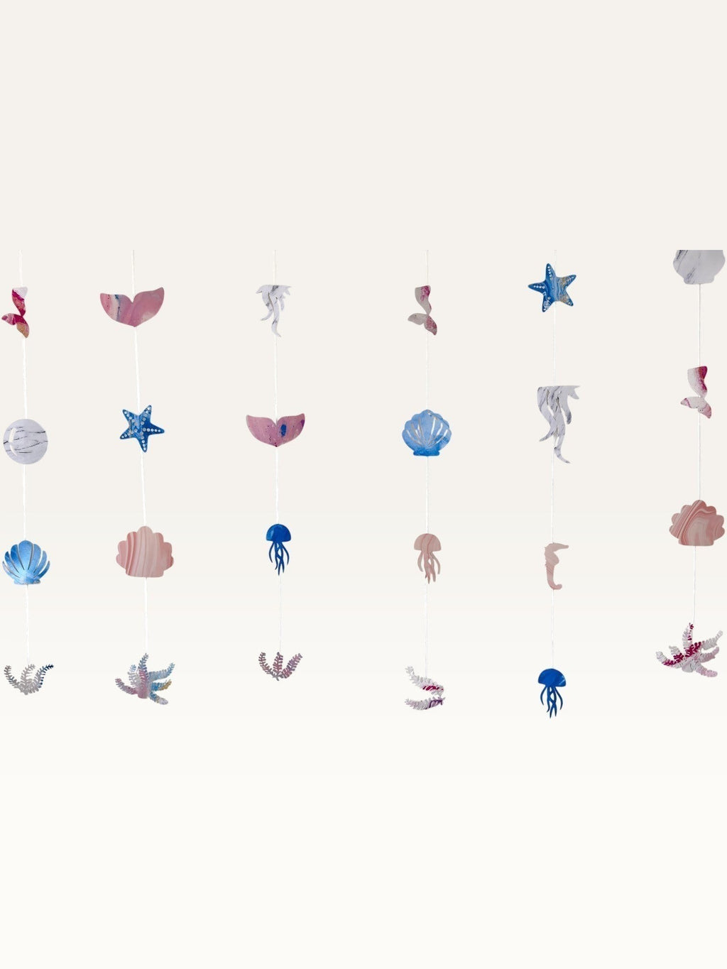 Paper Party Studio under the sea hanging backdrop with pink and blue mermaid, shell, and starfish cardstock cutouts.
