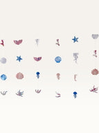 Paper Party Studio under the sea hanging backdrop with pink and blue mermaid, shell, and starfish cardstock cutouts.