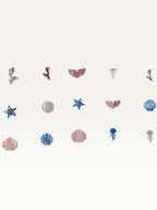 Paper Party Studio under the sea hanging backdrop with pink and blue cardstock mermaid tails, shells, and starfish.