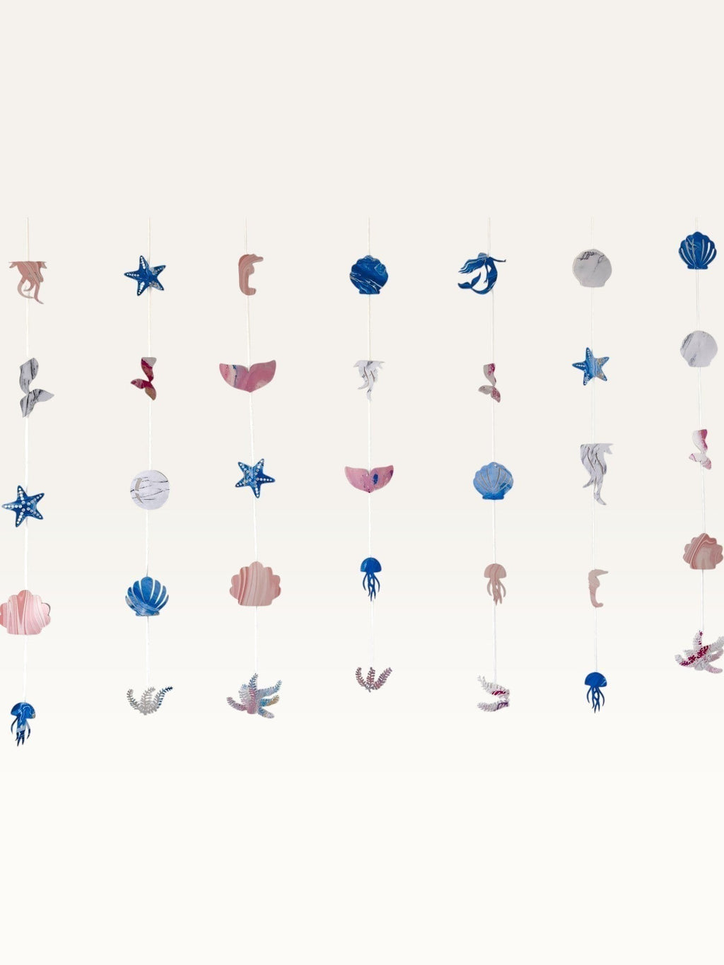 Paper Party Studio under the sea hanging backdrop with pink and blue cardstock mermaid, shell, and starfish shapes.