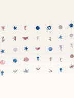 Paper Party Studio under the sea hanging backdrop with pink and blue cardstock mermaid, shell, and starfish shapes.