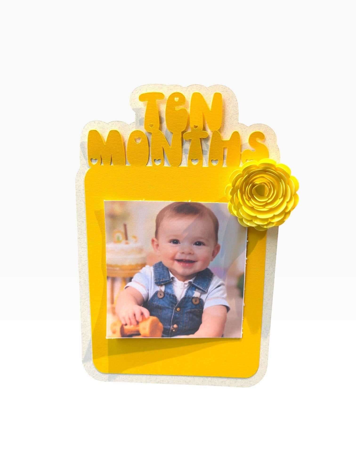 Paper Party Studio 10 month photo banner frame with a baby in denim overalls. Yellow paper rosette accent.