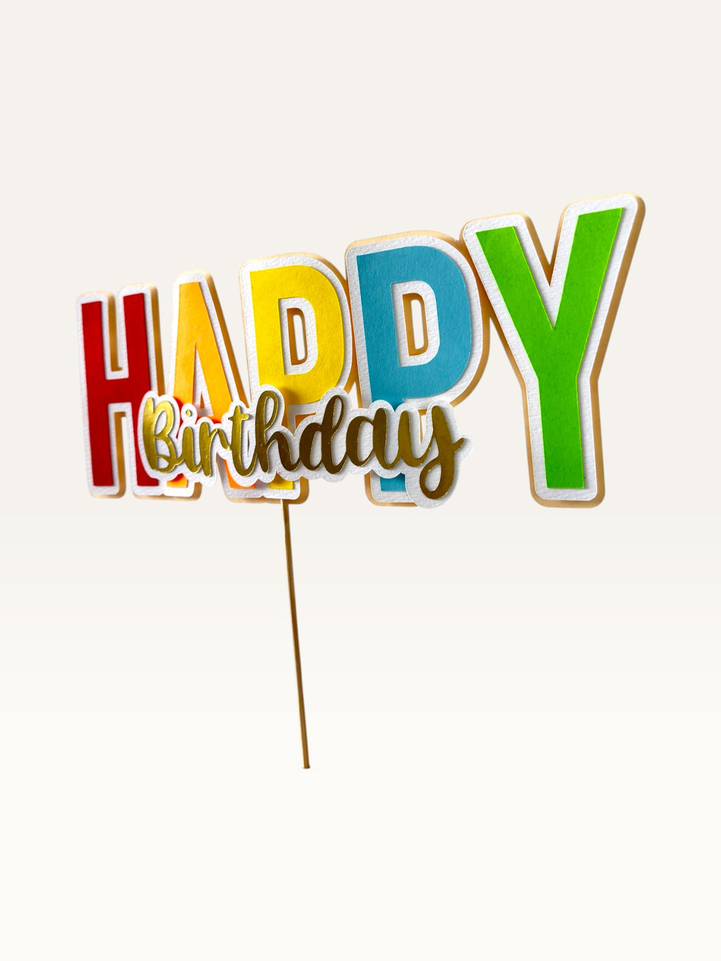 Paper Party Studio handmade multicolour block letter Happy Birthday cake topper with gold script and white outline.