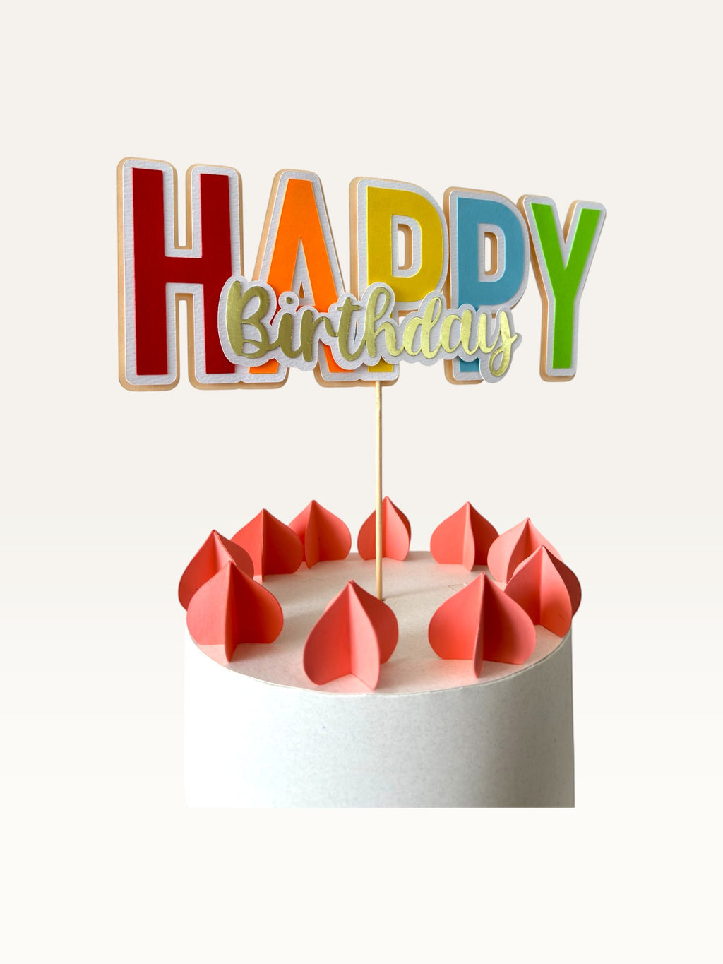 Paper Party Studio multicolour Happy Birthday cake topper with gold script lettering on a white cake