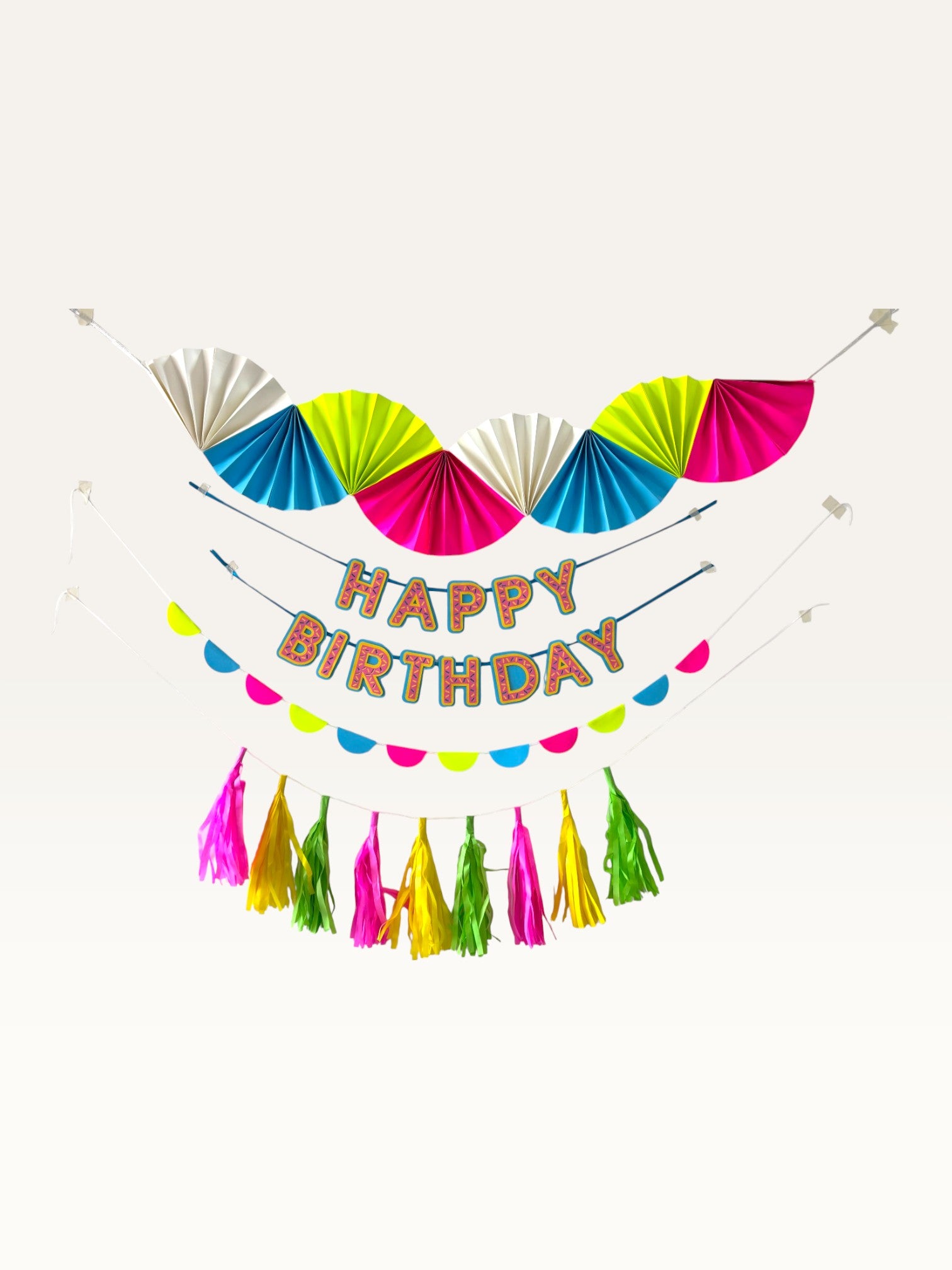 Paper Party Studio neon candy birthday decoration set with folding fans, Happy Birthday banner, and tassel garland.