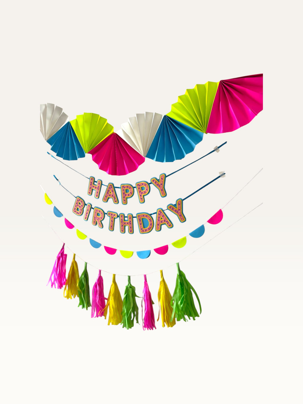 Paper Party Studio neon candy birthday decoration set with folded fans, Happy Birthday banner, and paper tassel garland.