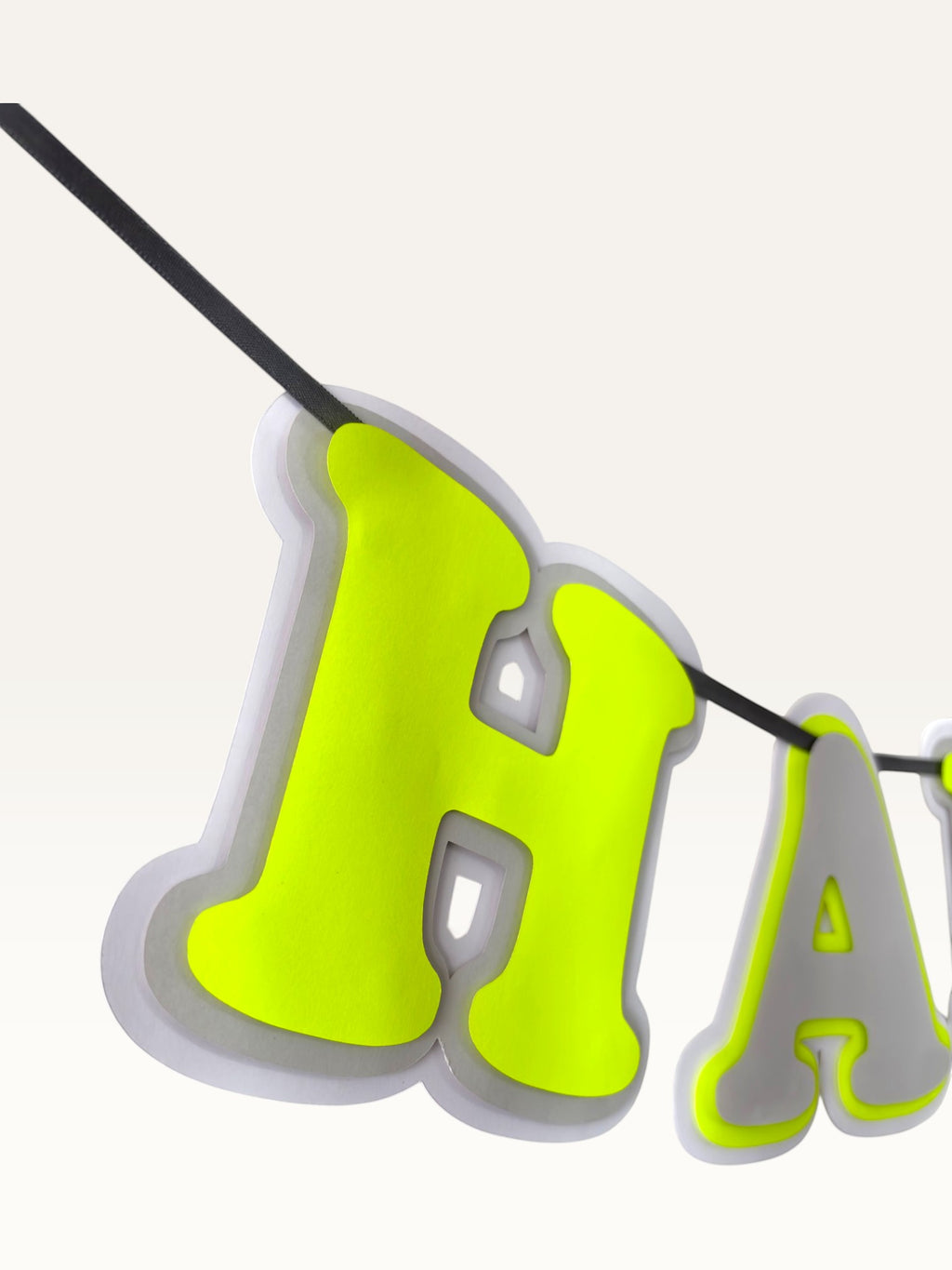 Paper Party Studio neon and grey layered paper Happy Birthday banner with dimensional cut-out lettering on a cord.