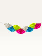 Paper Party Studio neon paper folding fan garland in bright pink, lime, blue, and white for birthday party decor.