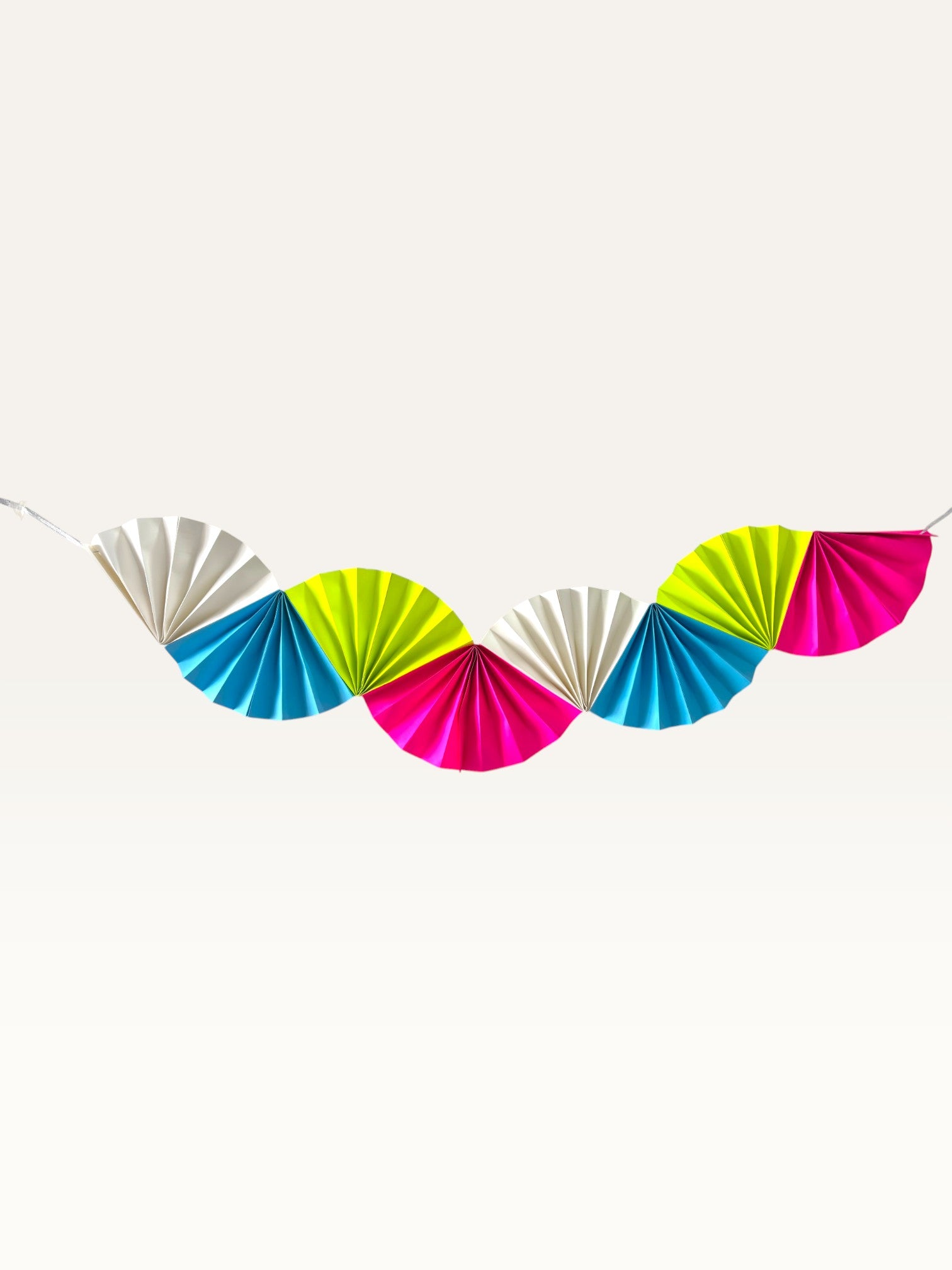 Paper Party Studio neon paper folding fan garland in bright pink, lime, blue, and white for birthday party decor.