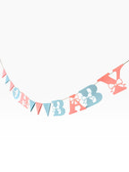 Paper Party Studio Oh Baby banner with pink and blue letters and bow cut-outs, interspersed with triangle pennants.