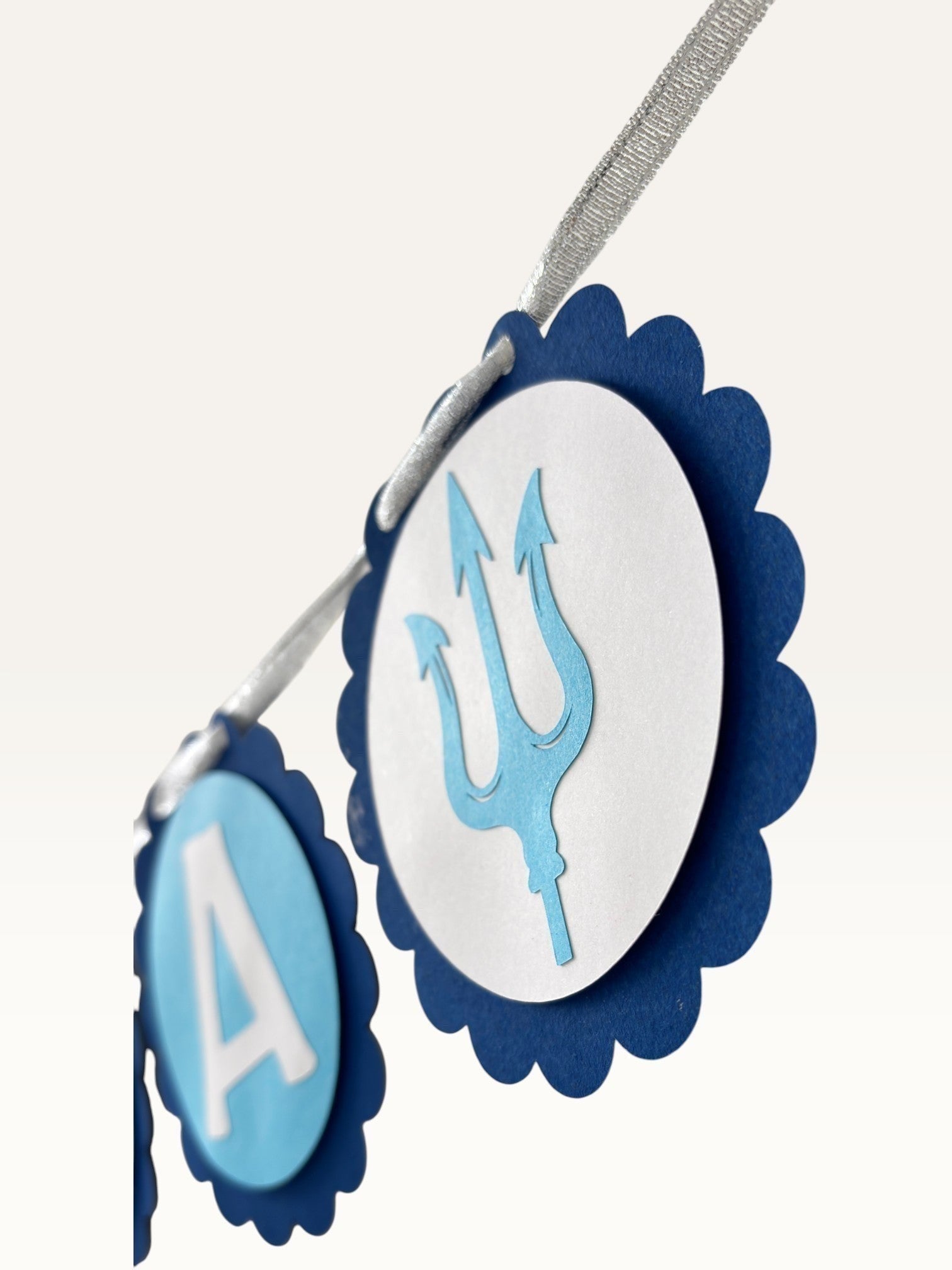 Paper Party Studio blue scalloped paper bunting with Om Namah Shivaya letters and trishul accents for festive decor.