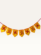 Paper Party Studio yellow and red paper pennant banner featuring traditional Om and Swastik motifs for Diwali decor.
