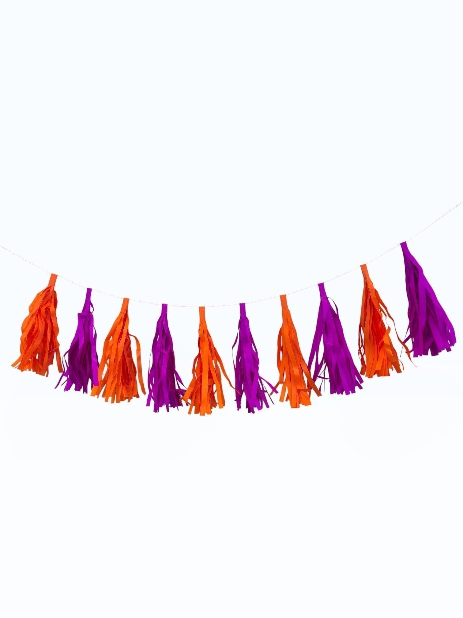 Paper Party Studio handmade tissue paper tassel garland in alternating vibrant orange and purple for party decor.