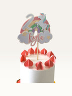 Paper Party Studio personalised unicorn cake topper with rainbow, glittery number 2, and name Kyra on a white cake