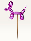 Paper Party Studio metallic pink balloon dog cake topper made of thick paper on a bamboo stick.