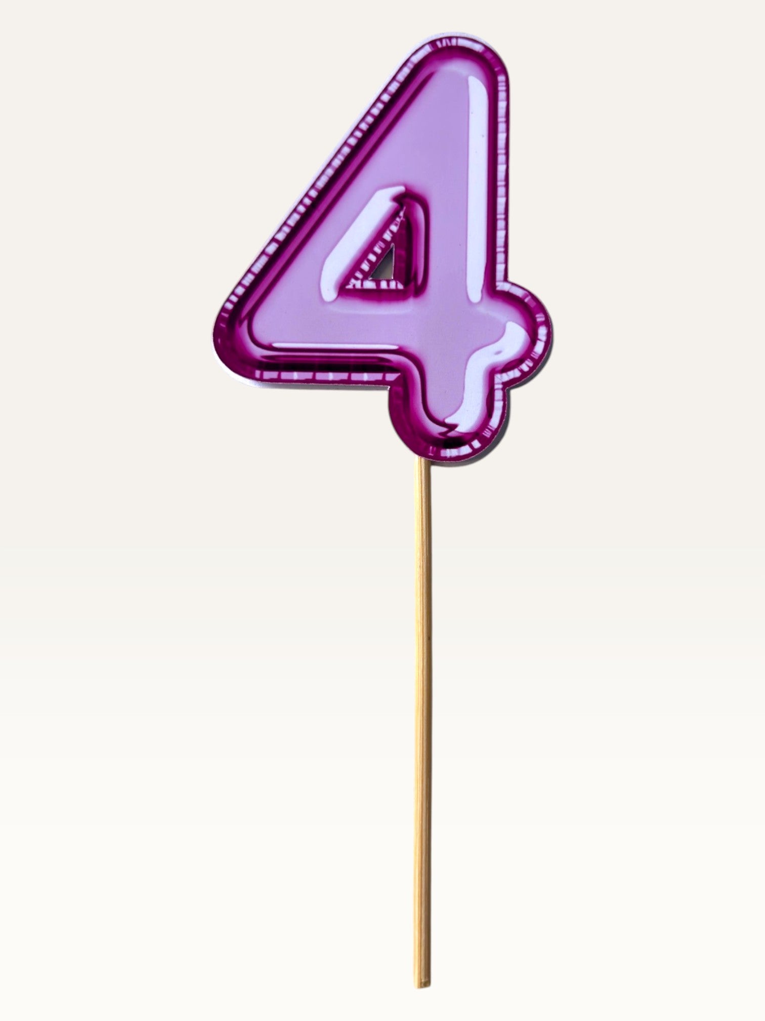 Paper Party Studio glossy pink foil number 4 cake topper on a bamboo stick for birthday cakes and cupcakes.