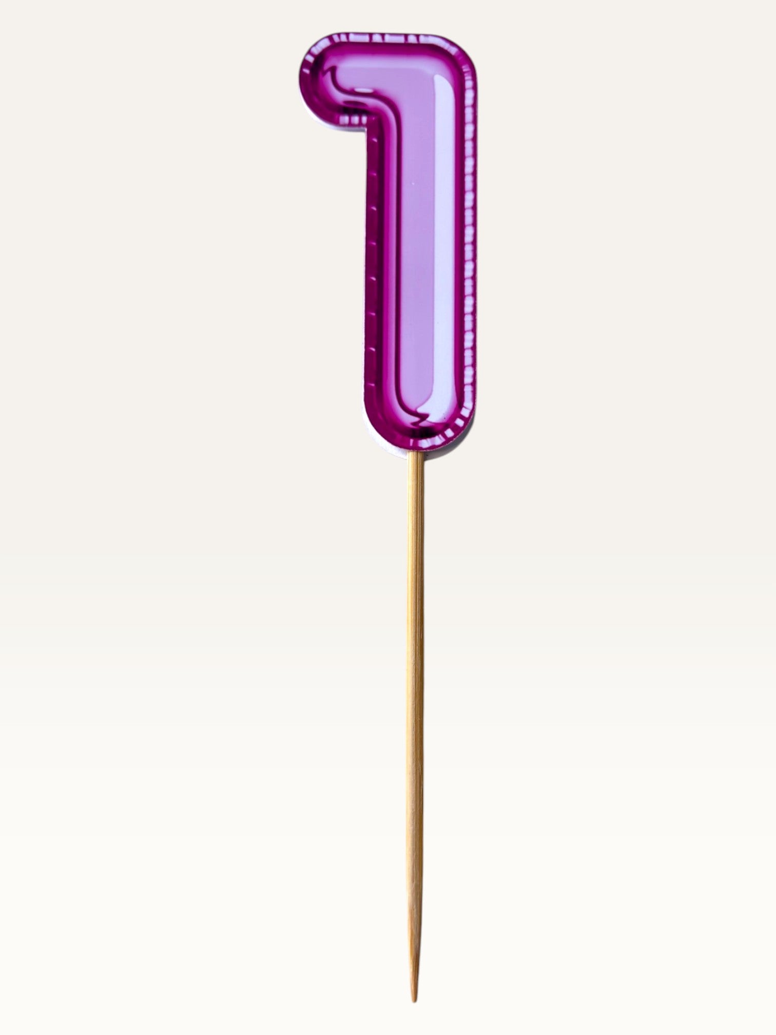 Paper Party Studio glossy pink foil number one cake topper on a bamboo stick for birthday celebrations.