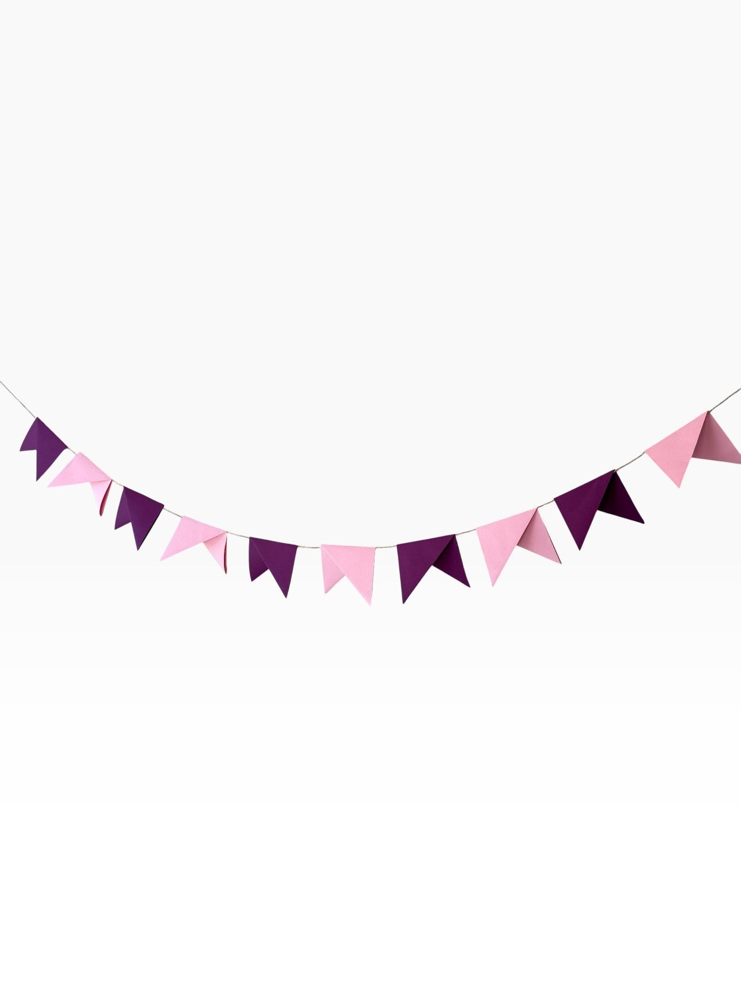 Paper Party Studio handmade paper bunting with alternating soft pink and deep purple pennant flags for celebrations.