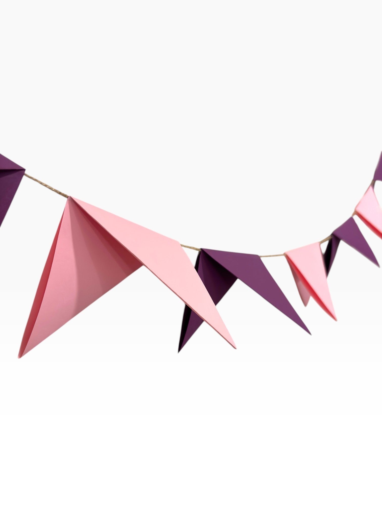 Paper Party Studio handmade paper bunting with alternating soft pink and deep purple pennant flags on string.