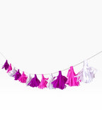 Paper Party Studio handmade tissue paper tassel garland in shades of pink, magenta, and white on a fine cord.