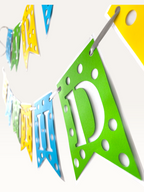 Paper Party Studio Happy Birthday banner with blue, green, and yellow polka dot swallowtail flags and white letters.