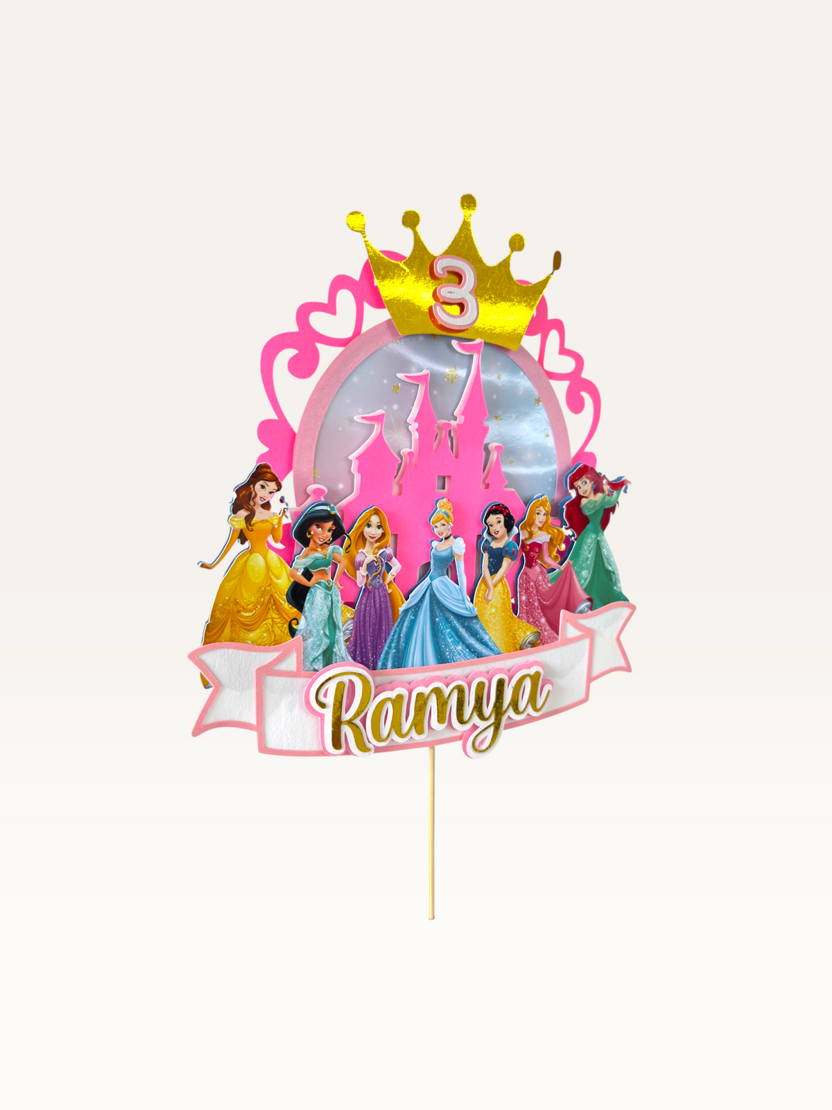 Paper Party Studio personalised princess cake topper with gold crown, pink castle, and Disney princess characters.