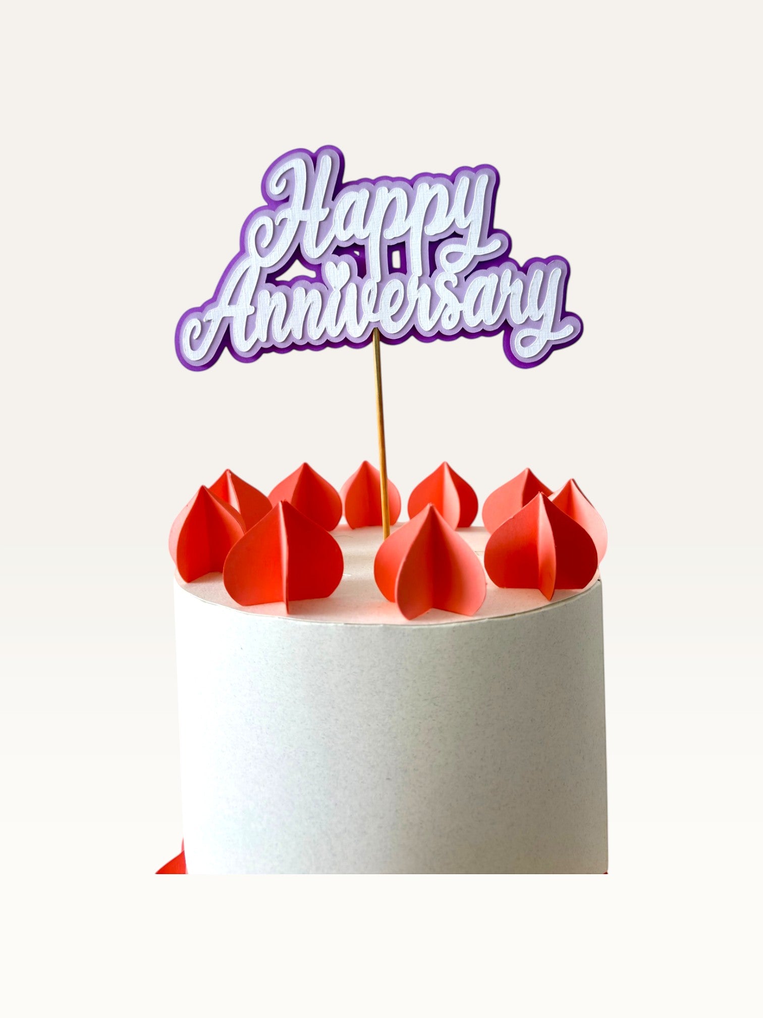 Paper Party Studio purple layered script Happy Anniversary cake topper with heart detail on a white cake